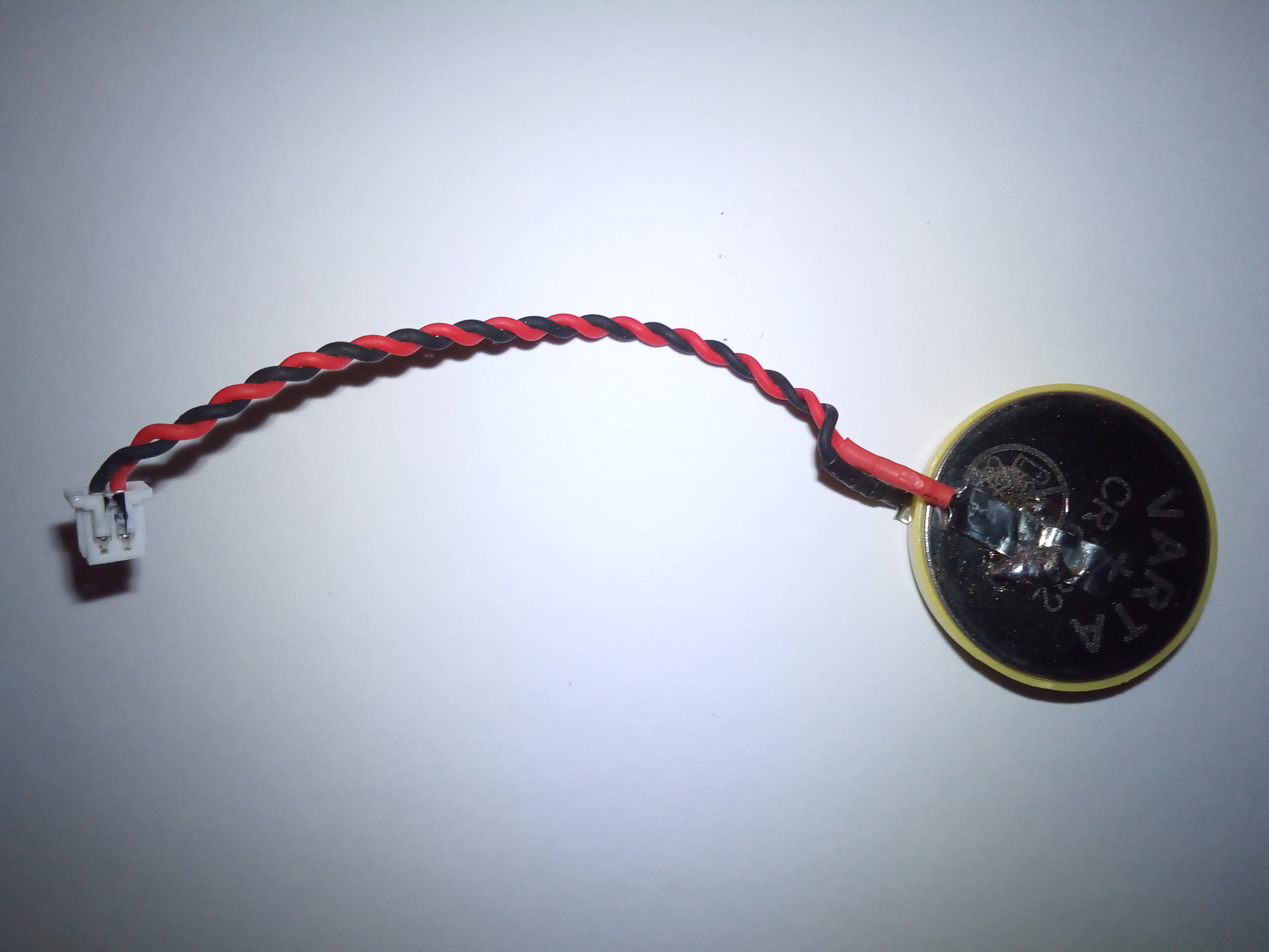 Neue CR2032 Knopfzelle mit Isolationsring an Schweißband gelötet